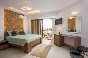 a hotel room with a bed and a balcony at Casa Lyristis in Faliraki +40 photos