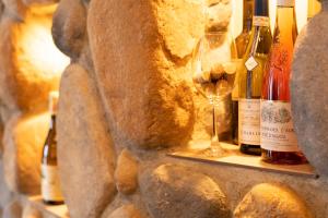 a shelf with wine bottles and a wine glass at Hashidate Bay Hotel in Yosano