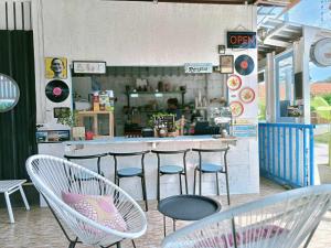 a restaurant with chairs and a counter with a bar at Forever Kohmook Bungalows in Koh Mook