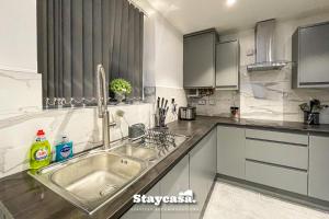 a kitchen with a sink and a counter at Live In Style House In Desirable Location in Manchester