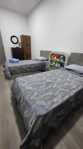 a bedroom with two beds in a room at RHR Deluxe GuestHouse Kinarut Papar Sabah - Mountain View in Papar