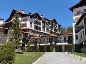 a large apartment building with a driveway at BH & Semiramida Ski Apartment in Borovets