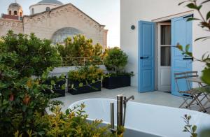 a bath tub in a yard with plants at Heart Hotel in Limassol