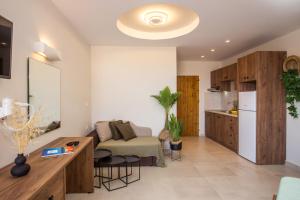 a living room with a couch and a kitchen at Casa Lyristis in Faliraki