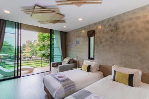 Ένα ή περισσότερα κρεβάτια σε δωμάτιο στο Sangthong Resort at Chiang Klang