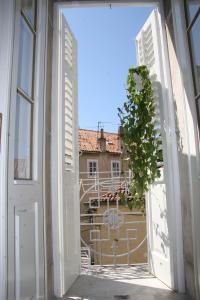 an open door to a balcony with a plant at Stylish Theatre Apartments in Split