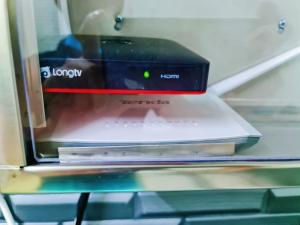 a laptop computer sitting on top of a shelf at Cozy Lunas House near to Kulim Hi Tech Park & BKE in Lunas +10 photos