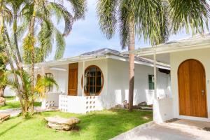 a house with palm trees in front of it at Sangthong Resort at Chiang Klang in Chiang Klang +85 photos