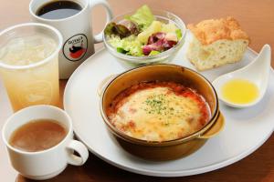 a plate of food with a bowl of soup and a salad at Richmond Hotel Yokohama-Bashamichi in Yokohama