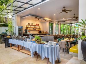 a dining room with tables and chairs and a restaurant at Grand Yard La Residence in Siem Reap