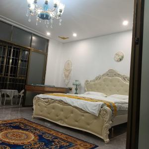 a bedroom with a large bed and a chandelier at Minsheng Apartment in Guangzhou