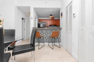 a dining room with a table and two chairs at Home Miami Downtown - 5 minutes from Wynwood & Port - near Beach in Miami