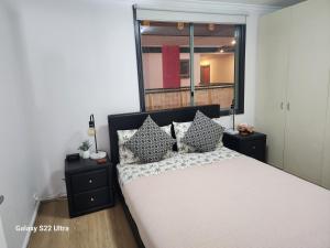 a bedroom with a bed with pillows and a window at Beautiful apartment in Pyrmont in Sydney