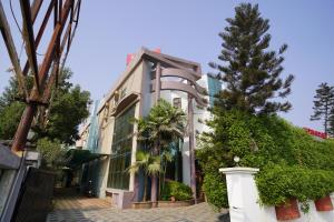 a building with a tree in front of it at HOTEL GOKUL in Gandhidham