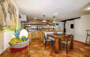 a kitchen with a table and a bowl of fruit at Awesome Home In Malataverne With Private Swimming Pool, Can Be Inside Or Outside in Malataverne