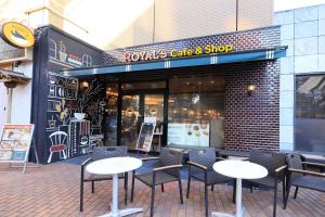 a group of tables and chairs in front of a store at Richmond Hotel Yokohama-Bashamichi in Yokohama