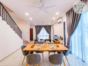 a dining room and living room with a table and chairs at Austin JT Homestay by JBcity Home in Johor Bahru