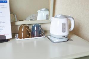 Příslušenství pro přípravu čaje a kávy v ubytování Hotel Machida Villa