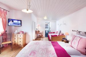 a bedroom with a bed and a table and chairs at Auberge de la Gare in Grandvaux