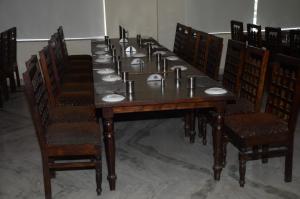 a long table with chairs and a long table with plates at Hotel Royal Fort - Chandwaji in Chandwaji