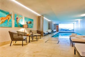 a living room with a swimming pool in a house at I love Sylt Hotel - adults only, hundefreundlich in Westerland