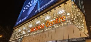 a neon sign on the front of a store at "Snooze Central" - above Victoria Centre Shopping Centre - most Central Location on Milton Street next to the Hilton Hotel - 2 Double Bedrooms with up to 4 Beds - Minutes to Motorpoint Arena - Outdoor Parking at five pounds a day in Nottingham