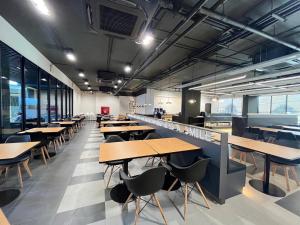 an empty cafeteria with tables and chairs in it at 9D City & 9D Express Hotel in Udon Thani