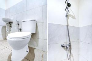 a bathroom with a toilet and a shower at De Plaza Hotel in Surabaya