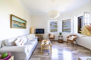 a living room with a couch and a tv at Théa Lassi 2 bedroom apartment, First floor in Argostoli