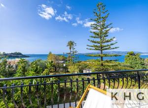 a view of the ocean from a balcony at Théa Lassi 2 bedroom apartment, First floor in Argostoli