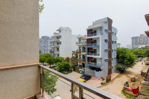 an apartment balcony with a view of a city at Hotel Royal Red Rohini Sector 23 in New Delhi