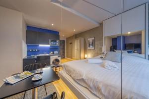 a large bedroom with a large bed and a table at Duployé N10 in Grenoble