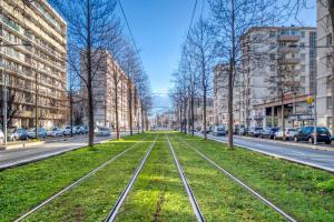 a street with trees and train tracks in a city at Duployé N10 in Grenoble