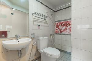 a bathroom with a toilet and a sink at RedDoorz Plus near Asia Afrika 3 in Bandung
