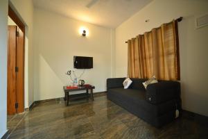 TV a/nebo společenská místnost v ubytování Coorg HomeStay Resort + 26 fotografií