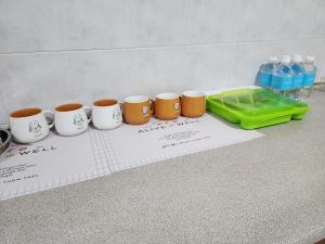 a group of coffee cups sitting on a counter at DE ELITE KUCHING HOMESTAY in Kuching