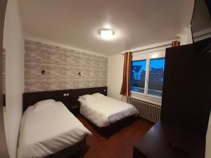 Postel nebo postele na pokoji v ubytování Hotel Au Spatial