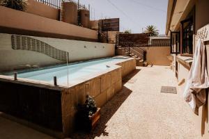 a swimming pool on the side of a building at Spacious home with pool 200M from beach in Cape Town