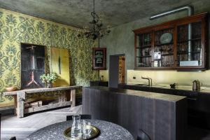 a kitchen with a counter and a sink and a table at Villa Castelli in Menaggio