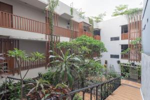 an external view of a building with plants at RedDoorz Plus near Asia Afrika 3 in Bandung