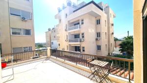 balkon z widokiem na budynek w obiekcie Cozy Beach Apt / Near Airport + 100Mbit internet + Netflix w Larnace
