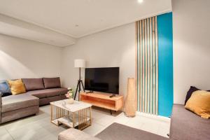 a living room with a couch and a flat screen tv at City Center 2 Bedroom House Pyrmont 2 E-Bikes Included in Sydney