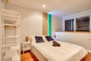 a bedroom with a white bed and a window at City Center 2 Bedroom House Pyrmont 2 E-Bikes Included in Sydney