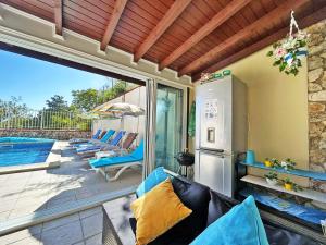 a patio with a couch and a refrigerator at Villa Regina Bella in Balchik