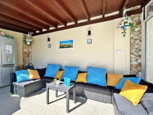 a living room with blue and yellow pillows on a couch at Villa Regina Bella in Balchik +58 photos