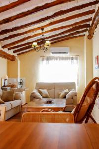 a living room with a couch and a table at EL TEULAR DE CARMEN in Banyeres de Mariola
