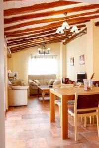 a living room with a table and a couch at EL TEULAR DE CARMEN in Banyeres de Mariola +39 photos