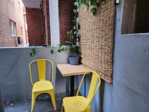 two yellow chairs sitting next to a table with a plant at Newly Renovated 2 Bedroom Apartment in Seoul