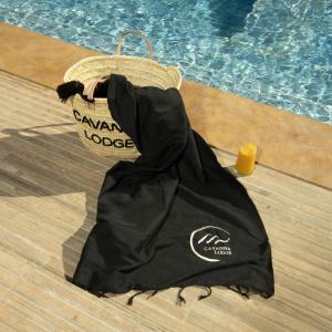 a black towel sitting next to a swimming pool at Cavanna Lodge in Essaouira