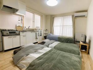 a kitchen with three beds in a room at 新三条Home 402 in Asahikawa